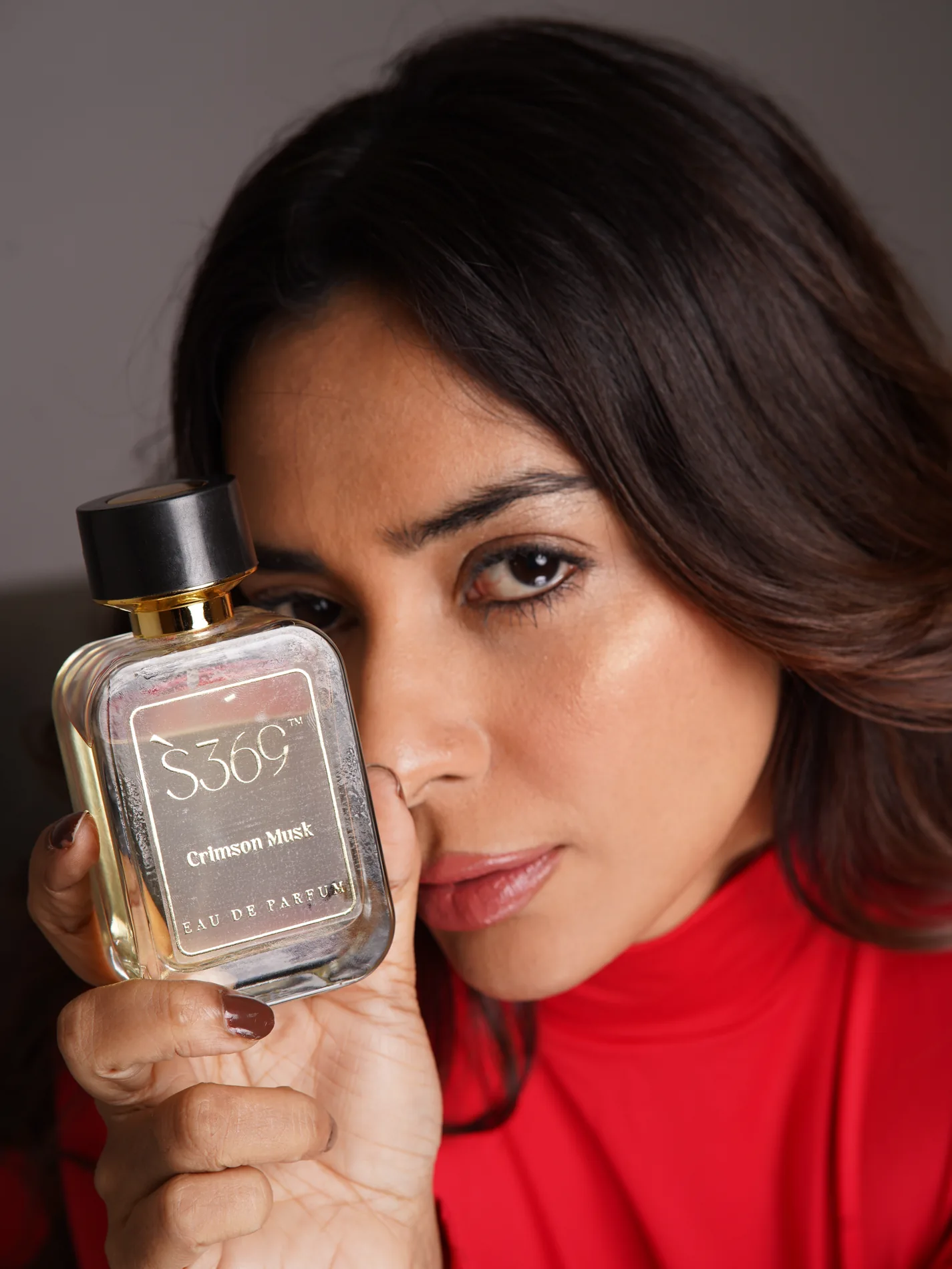 Model holding S369 Alpha 9 perfume